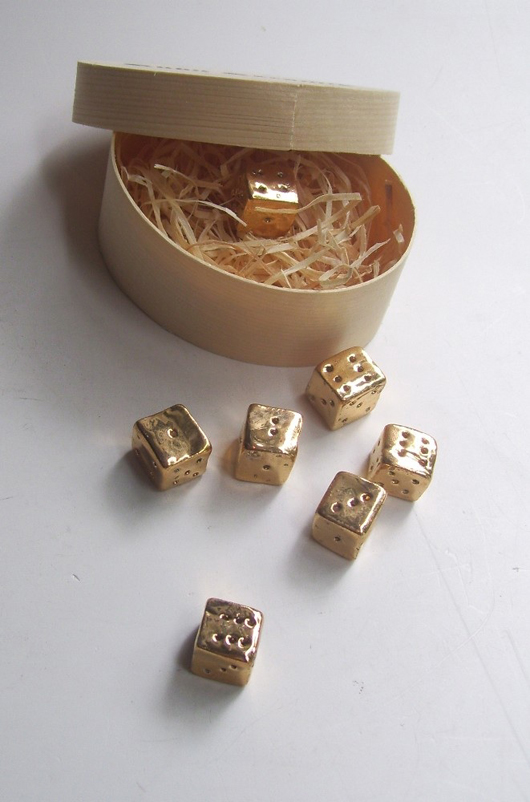 The Courtauld Gallery Shop at Somerset House has produced a range of affordable objects for Christmas inspired by works in its collection. These handcrafted, gold-plated dice can be purchased at 35 pounds  ($56) per set. Image courtesy Courtauld Gallery.